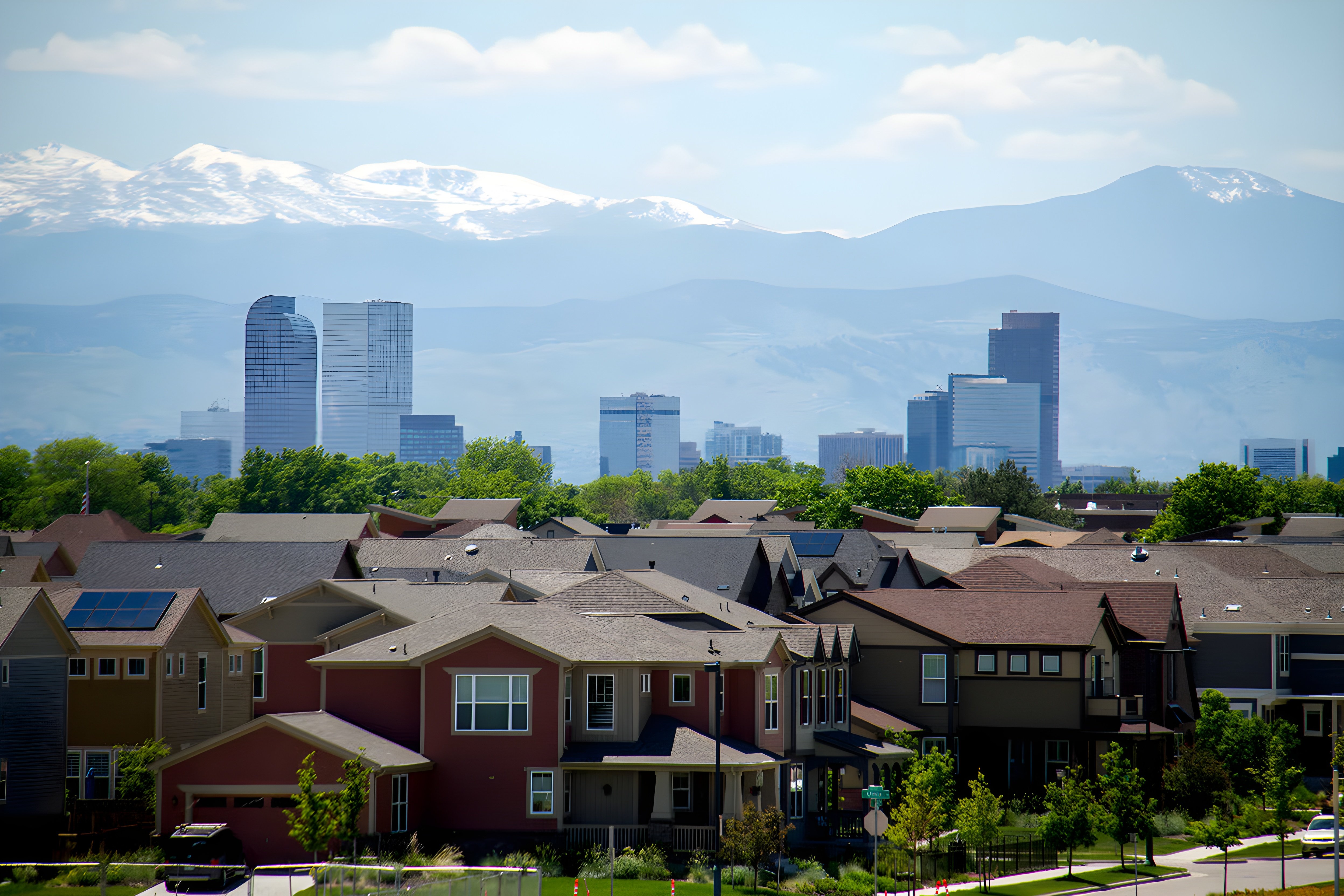 Cityscape with suburban homes and downtown skyline under surveillance